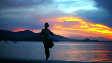 Young woman doing yoga exercise on the background