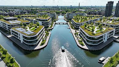 Aerial View of White Buildings with Green Roofs Along a Canal in Dusseldorf Germany on a Bright Sunny Day with Trees