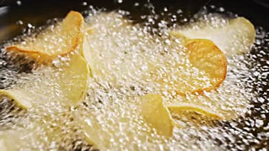 Golden Cassava Chips Frying in Hot Oil Close Up View Crispy Texture Bubbling Oil Culinary Background Food Preparation