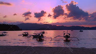 Traditional bancas in Port Barton bay during sunset. Best aerial view drone