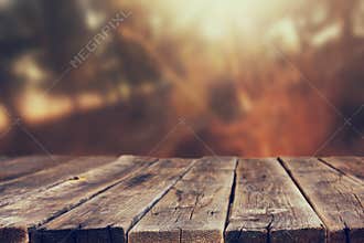Wood boards and nature backgrounds of summer light among trees