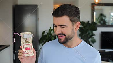 Man showing how to catch a mouse