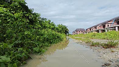 stagnant pool of rainwater along the diminishing perspective rural pathway into the rural countryside