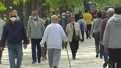 Old people walking in Madrid, Spain during the first day of measures to lift restrictions