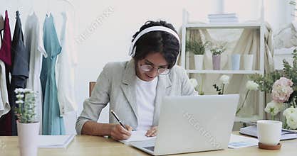 Happy young beautiful businesswoman improving skills on online courses.