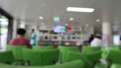 Blurred, People sitting on green chairs waiting in queue to wait for treatment from doctors in the Hospital
