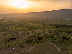 Aerial Drone Shot. Traditional Masai village at Sunset time near Arusha, Tanzania