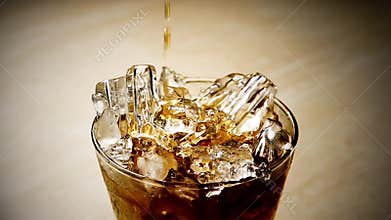 HD 1080p super slow Whiskey being poured into a glass against yellow background. Macro. Slow motion.