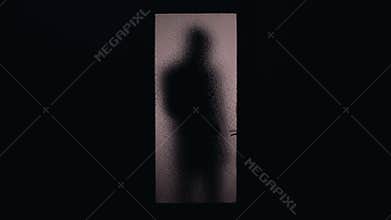 Dark shadow of hooded man coming and opening glass door, danger of burglary