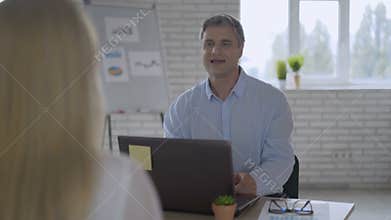 Friendly male employer handshaking welcoming new employee after successful job interview, smiling businessman making