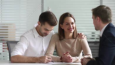 Happy couple sign loan investment contract handshake bank manager