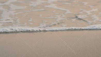 4K. soft wave of the sea , clear water on the white sand beach with copy space area. tropical summer sea beach
