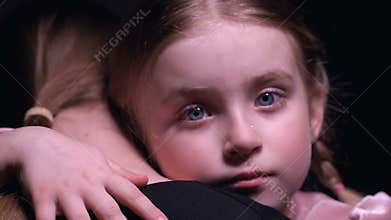 Little girl with tears on face hugging foster mother, orphan kid needing family