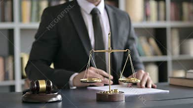 Close up of lawyer hands writing documents in court room