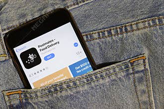 Los Angeles, California, USA - 10 October 2019:  Mobile phone with Postmates icon on App Store, logo on screen close up in the blu