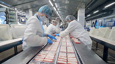 Packaging of crabs sticks carried out by female plant staff