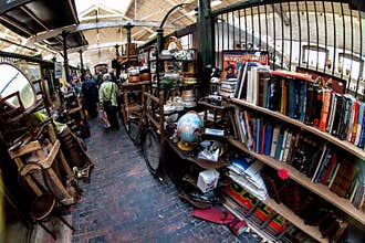 London, United Kingdom - April 01, 2007: Extreme wide angle - fisheye - photo. Stalls with various used stuff, mostly books,
