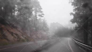 Driving down a winding mountain road on a rainy day
