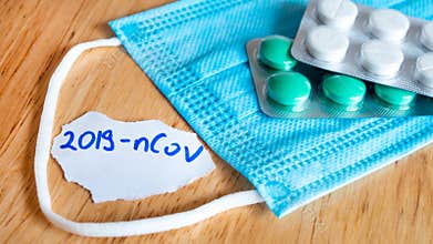 Medical face mask and pills with inscription Wuhan coronavirus 2019-nCoV