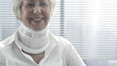 Doctor examining an injured senior woman with cervical collar