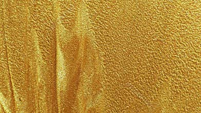 Glitter paint texture yellow grainy fluid motion