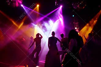 Silhouettes of dancing teenagers