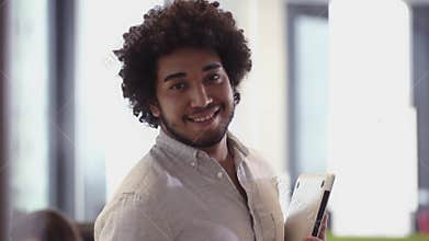 Portrait of bearded middles eastern business man smiling in office