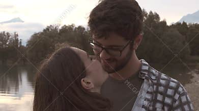 Sweet young loving couple dating at the lake