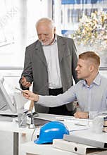 Young architect discussing work with boss