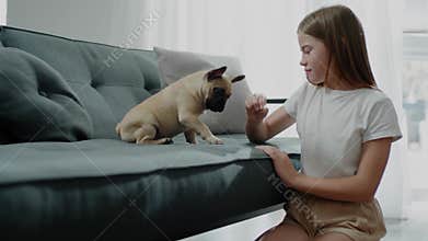 Teenager Plays With Puppy in Big Apartment.