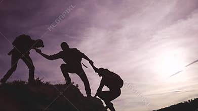 Teamwork help business travel silhouette concept. group team of lifestyle tourists lends a helping hand climb the cliffs