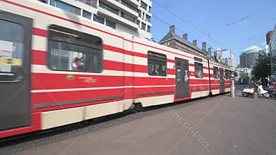 Red and light brown tram in The Hague city center