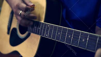 Man playing guitar close up.