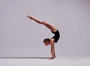 Beautifull flexible blonde girl posing. Gymnastics.