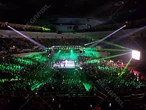 WWE Wrestler makes entrance in ring with crowd watching at WWE event