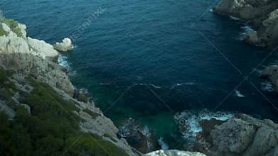 Palma de Mallorca, Spain,beautiful cliffs, high-up view, rocks and many plants and trees, sea in the background, Spanish flora