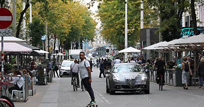 Vienna, Austria - 16 September: Typical Viennese city life, people are walking and cycling around pedestrian street Mariahilfer St