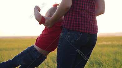 A happy little girl runs into the arms of her loving mother. The happiness of motherhood, friendship, trust, love.