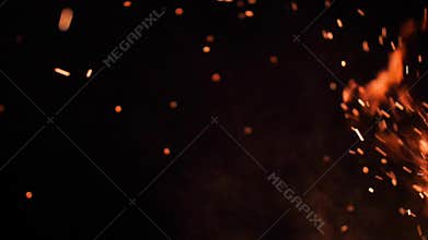 Flying sparks from the camp fire, at night