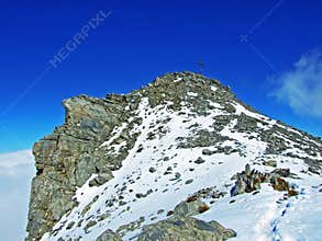 Alpine peak Falknis in the Ratikon border mountain massif or Raetikon Grenzmassiv and over the river Rhine valley Rheintal