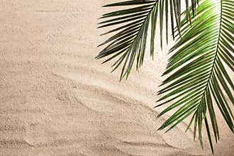 Cross and Palm Tree Leaves on sand. Palm sunday concept. Top view