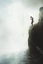 Fisherman on top of a rock hopes for abundant fishing, concept of success