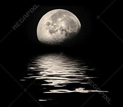 Summer moon setting over sea ocean water at night with beautiful reflection