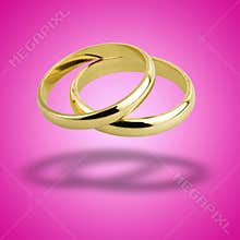 old wedding rings floating against pink background