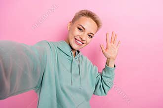 Photo selfie of young optimistic smiling blonde hair vlog star palm up hello video blog stream new video isolated on
