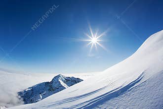 Snowy mountain landscape in a winter clear day.