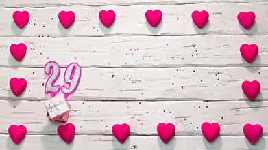 Happy birthday 29 card  for a girl in pink shades, top view, copy space. Beautiful congratulations with numbers and hearts