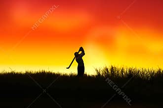 Miniature people toy figure photography. Silhouette of men golfer swing his stick at meadow field hill when sunset sunrise