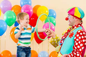 Clown amusing child boy on birthday party