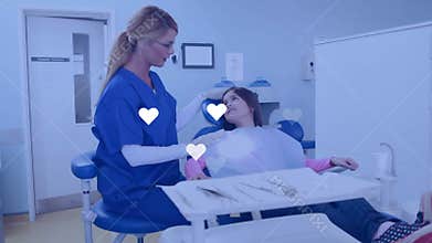Dental professional greeting child patient, placing gloved hand and aligning overhead lamp for exam